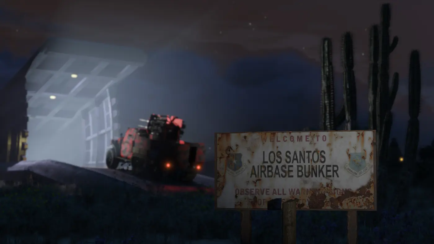 Entrance to a GTA Online underground bunker at night, its massive armored door open, a weaponized vehicle rolling out, a rusted sign and cacti in the desert