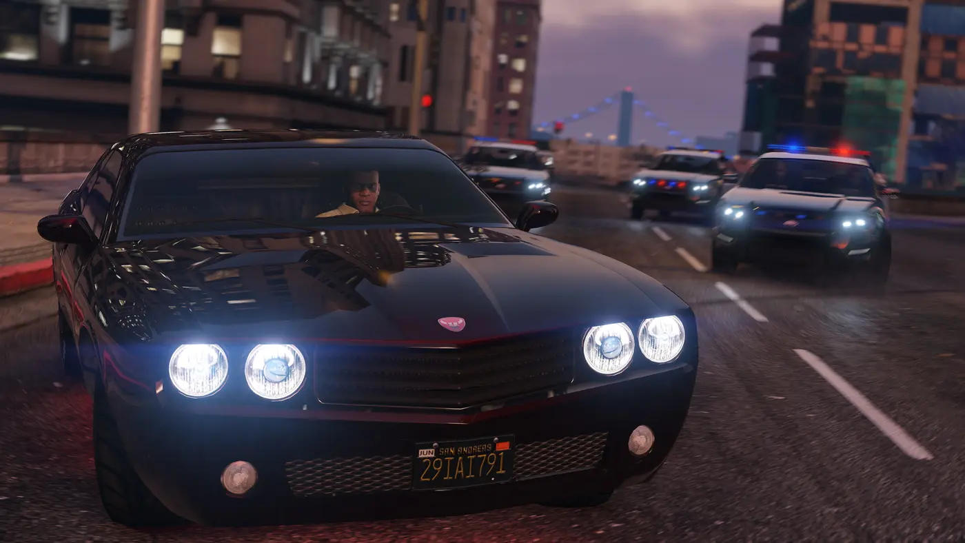 Franklin behind the wheel of a black muscle car on a downtown Los Santos street in GTA 5, chased by several police cruisers