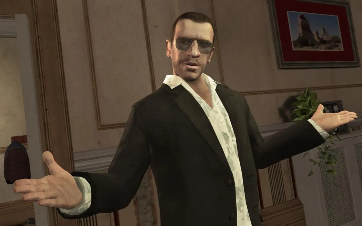 Niko Bellic, in sunglasses and a dark blazer over a patterned shirt, spreads his arms in a Liberty City apartment in GTA IV